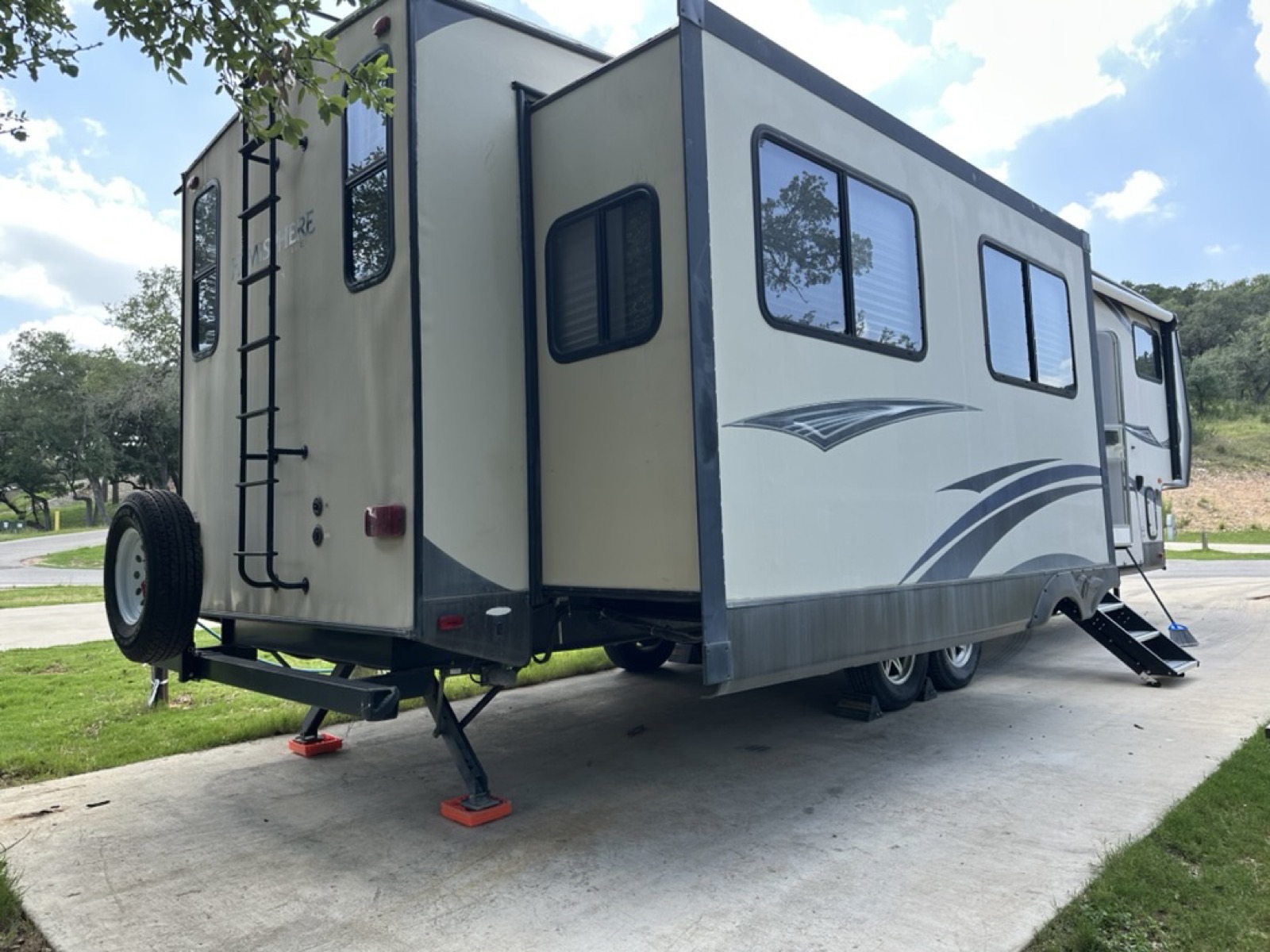 Rear three-quarter view of the Hemisphere Lite with spare tire and roof ladder