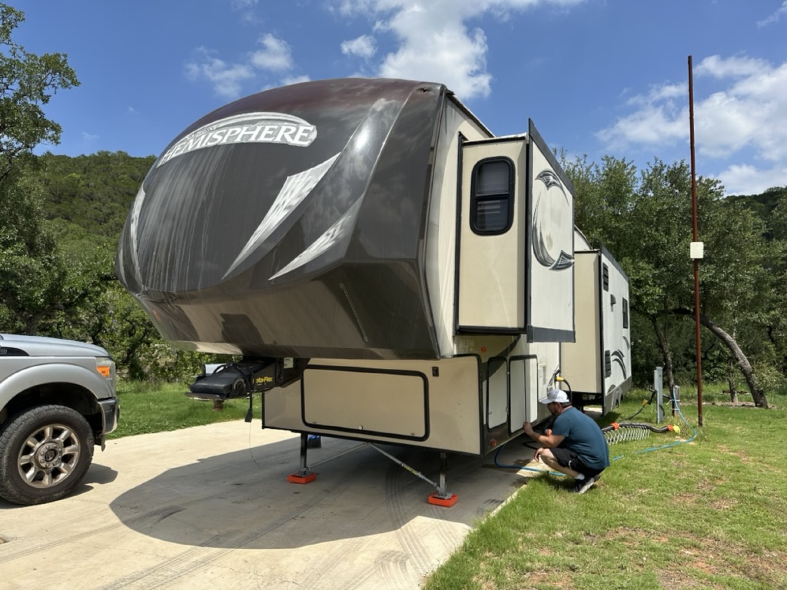 Host leveling and connecting the Hemisphere fifth wheel at a Hill Country campsite